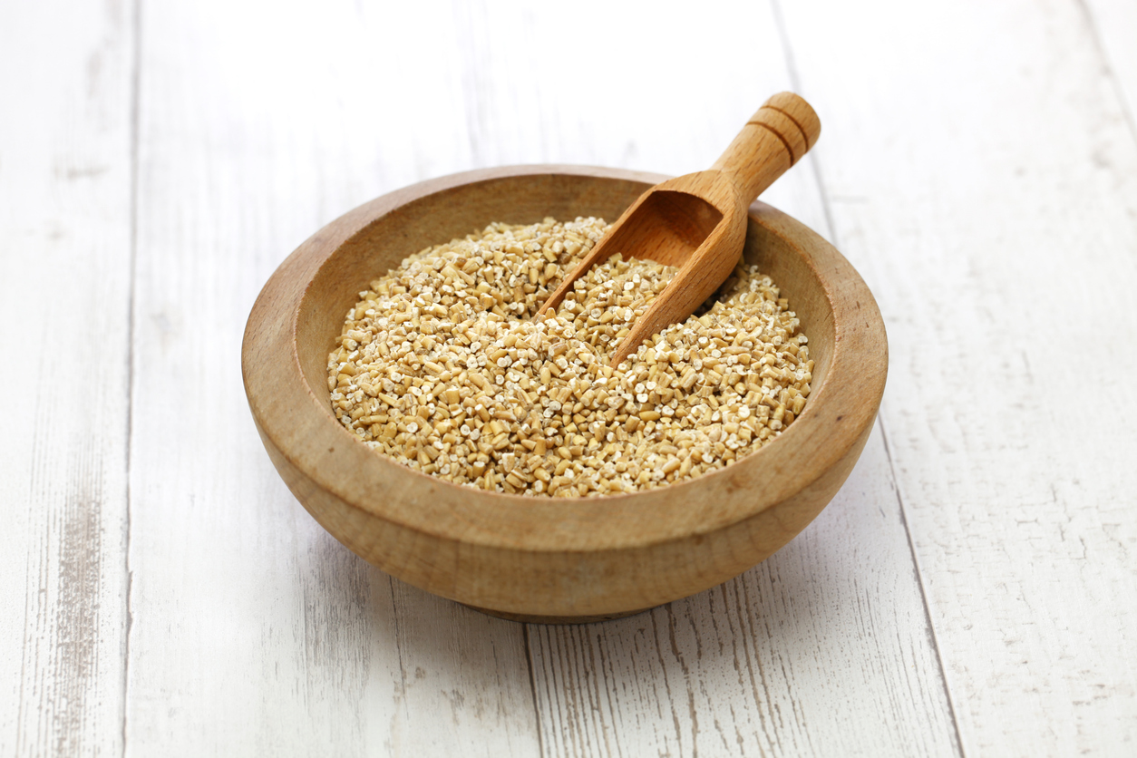 organic pinhead oatmeal in a wooden bowl
